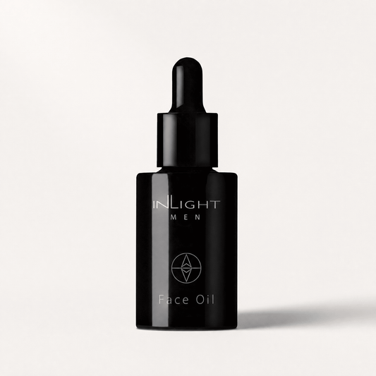 Black face oil dropper bottle with Inlight Beauty Face Oil for Men 30ml branding on a light grey background