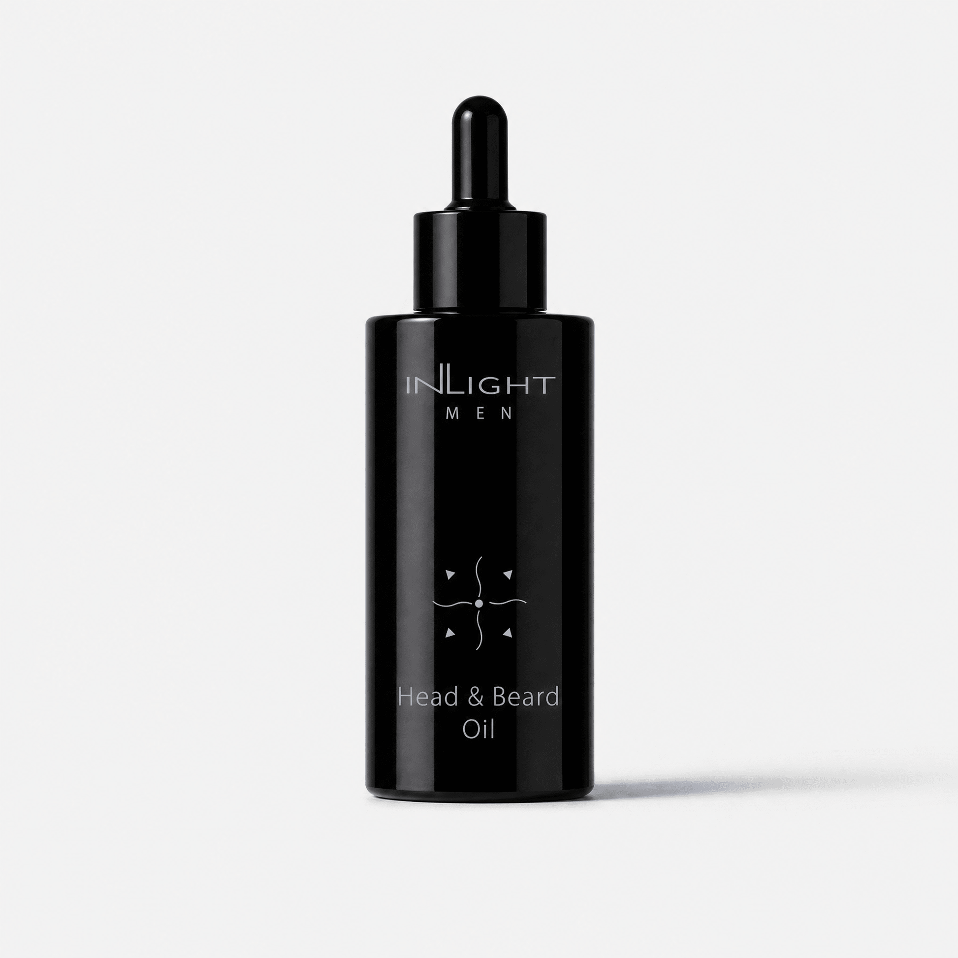 A black dropper bottle of Inlight Beauty Head & Beard Oil for Men 100ml on a light grey background.