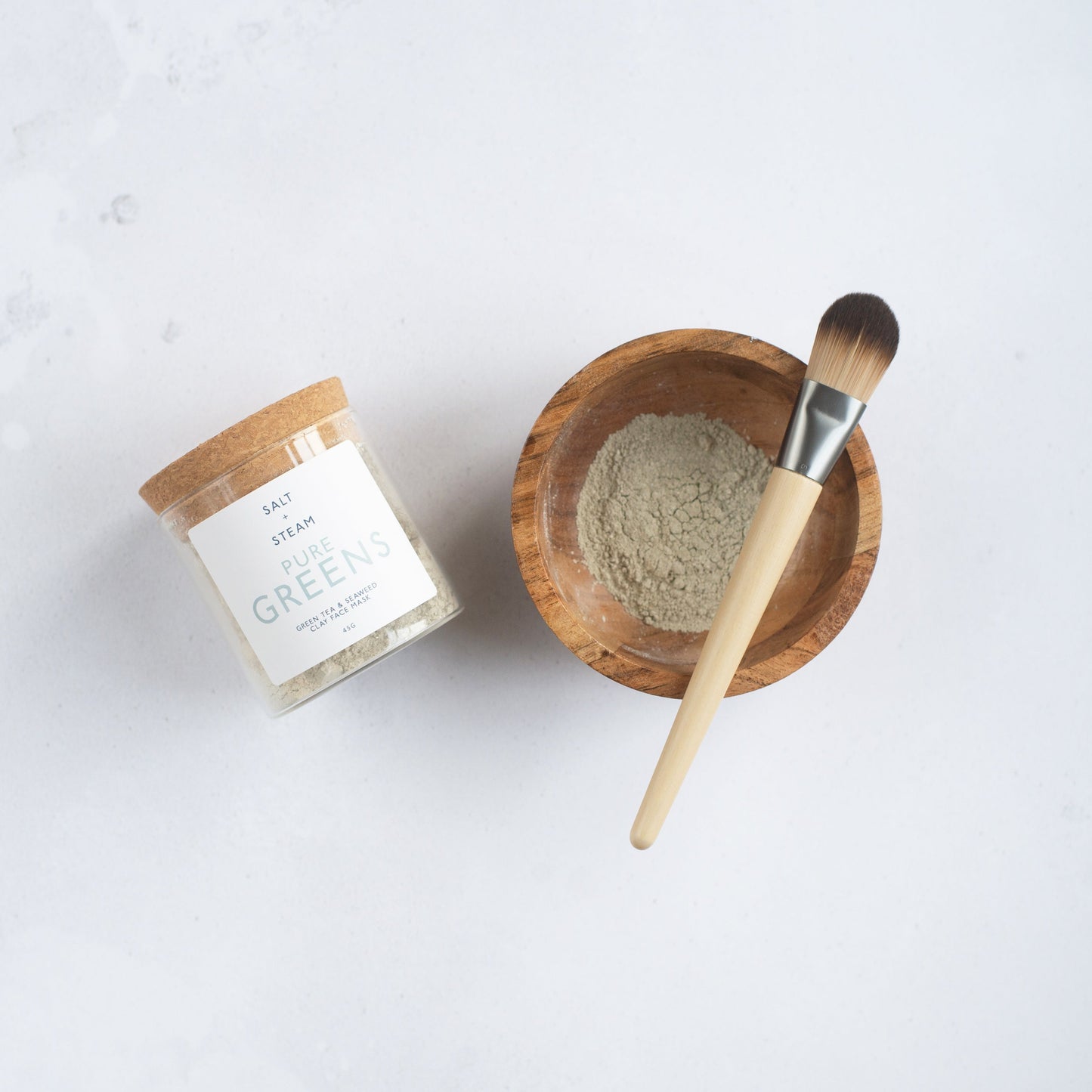 Salt + Steam Pure Greens clay face mask being applied
