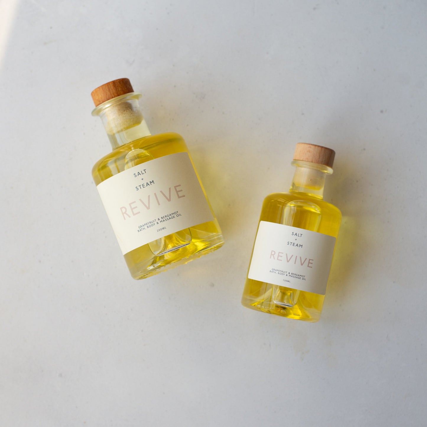 Salt + Steam Revive bath oil melting into bath water