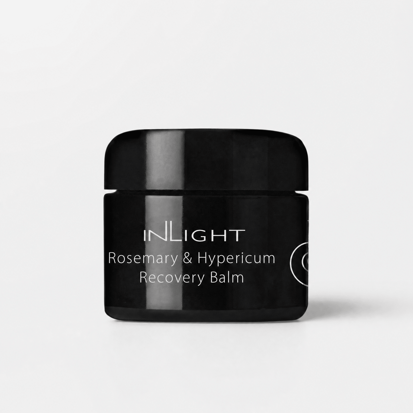 Black jar of Inlight Beauty Rosemary & Hypericum Recovery Balm 45ml on a light grey background