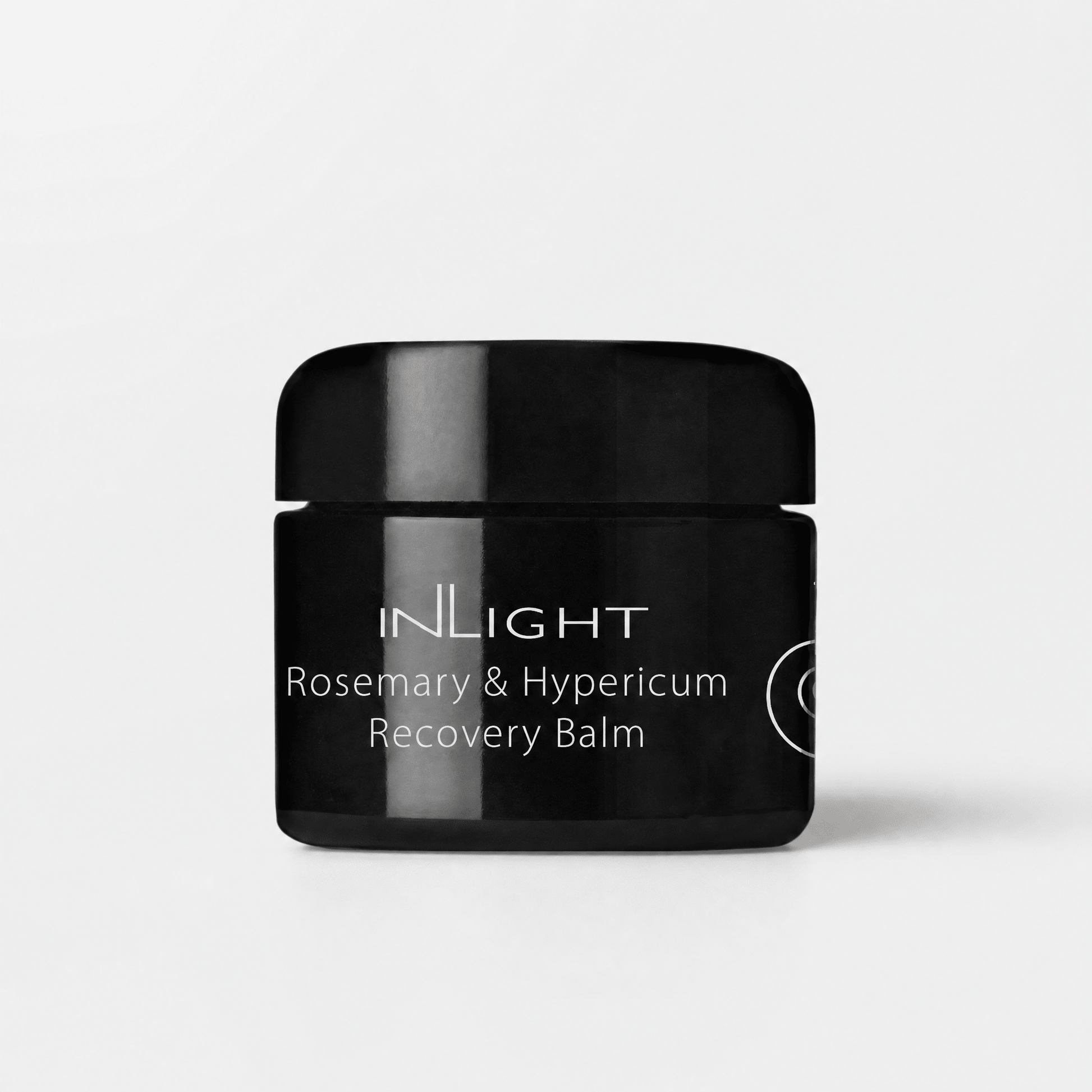 Black jar of Inlight Beauty Rosemary & Hypericum Recovery Balm 45ml on a light grey background