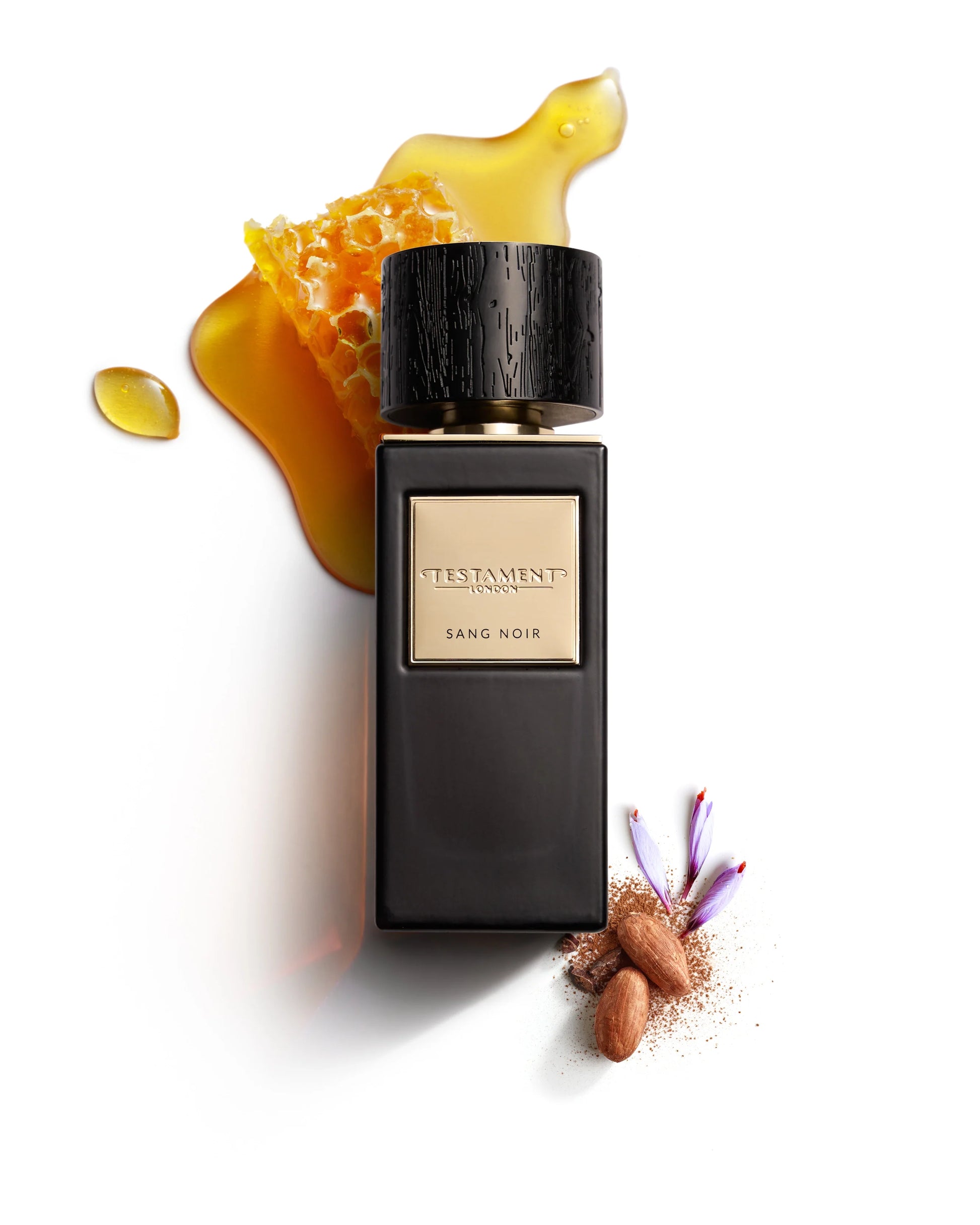 Perfume bottle labeled 'Sang Noir' with honeycomb and almonds on a white background