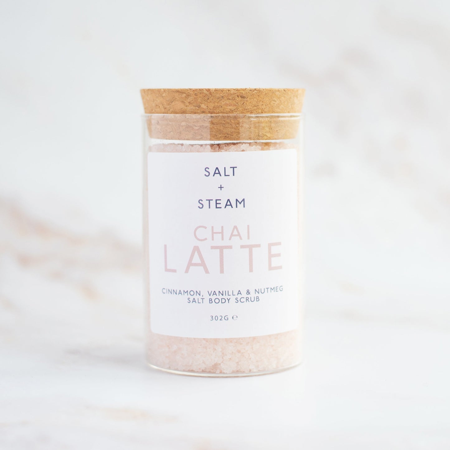Salt + Steam Chai Latte body scrub being applied to skin