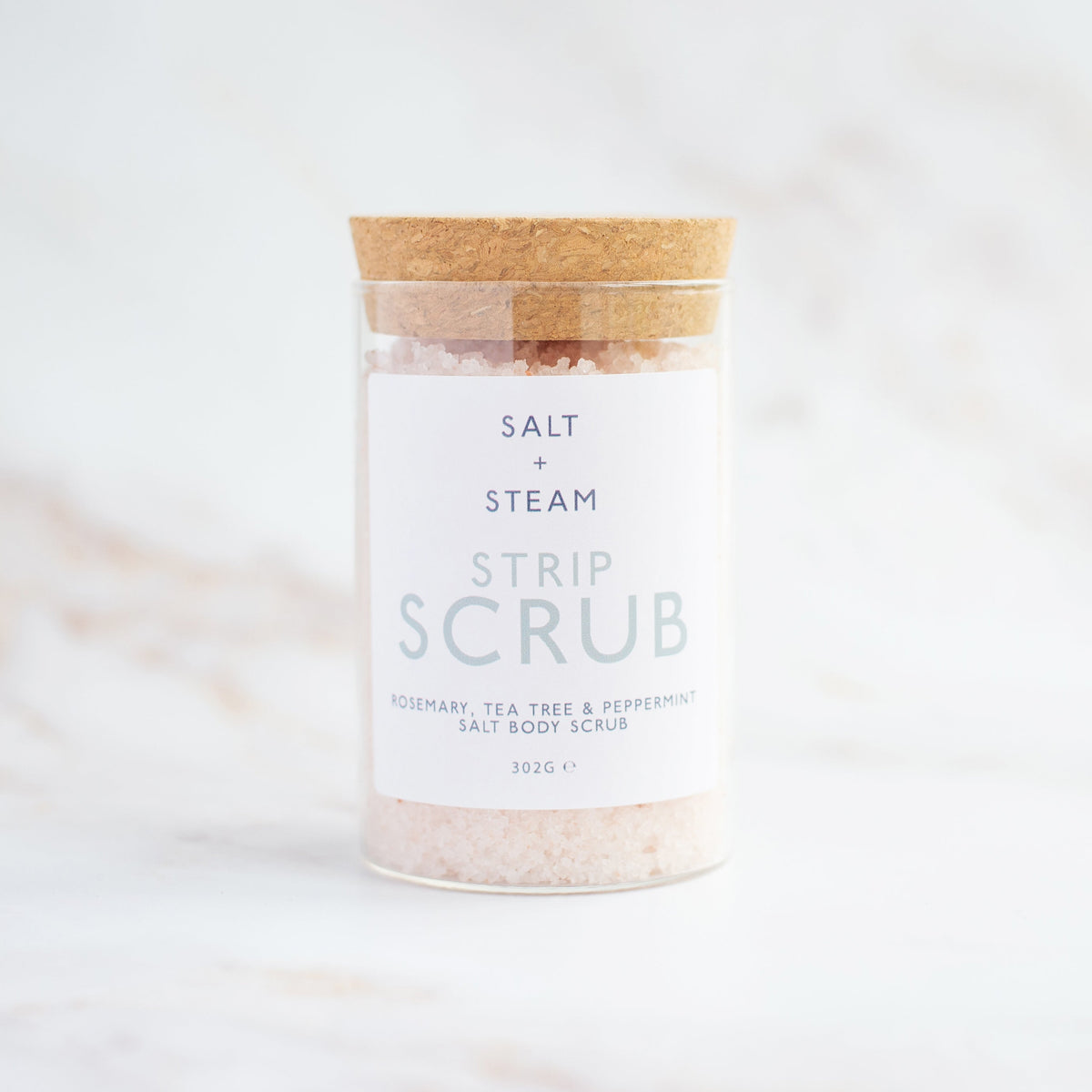 Salt + Steam Strip Scrub body scrub being applied to skin