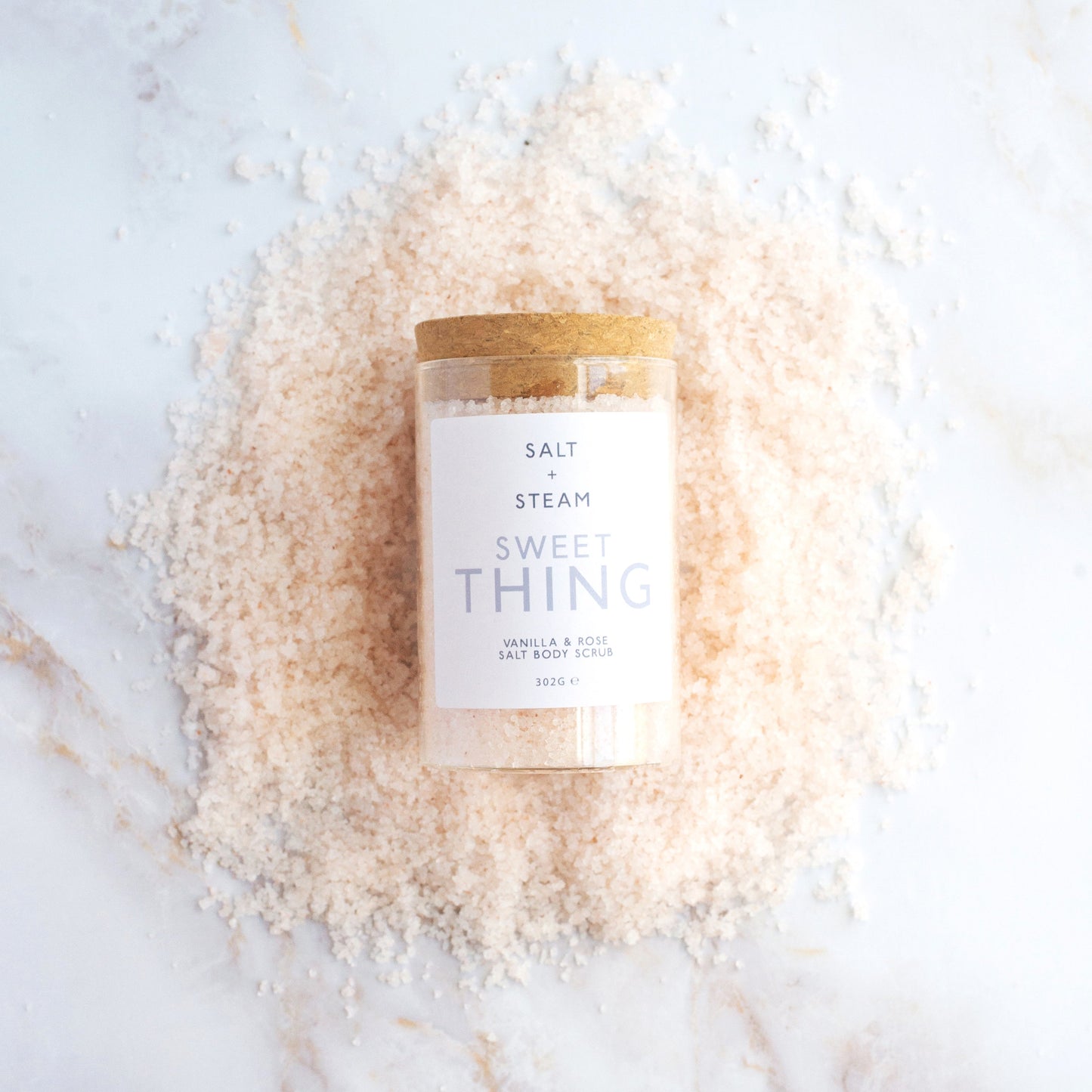 Salt + Steam Sweet Thing body scrub being applied to skin