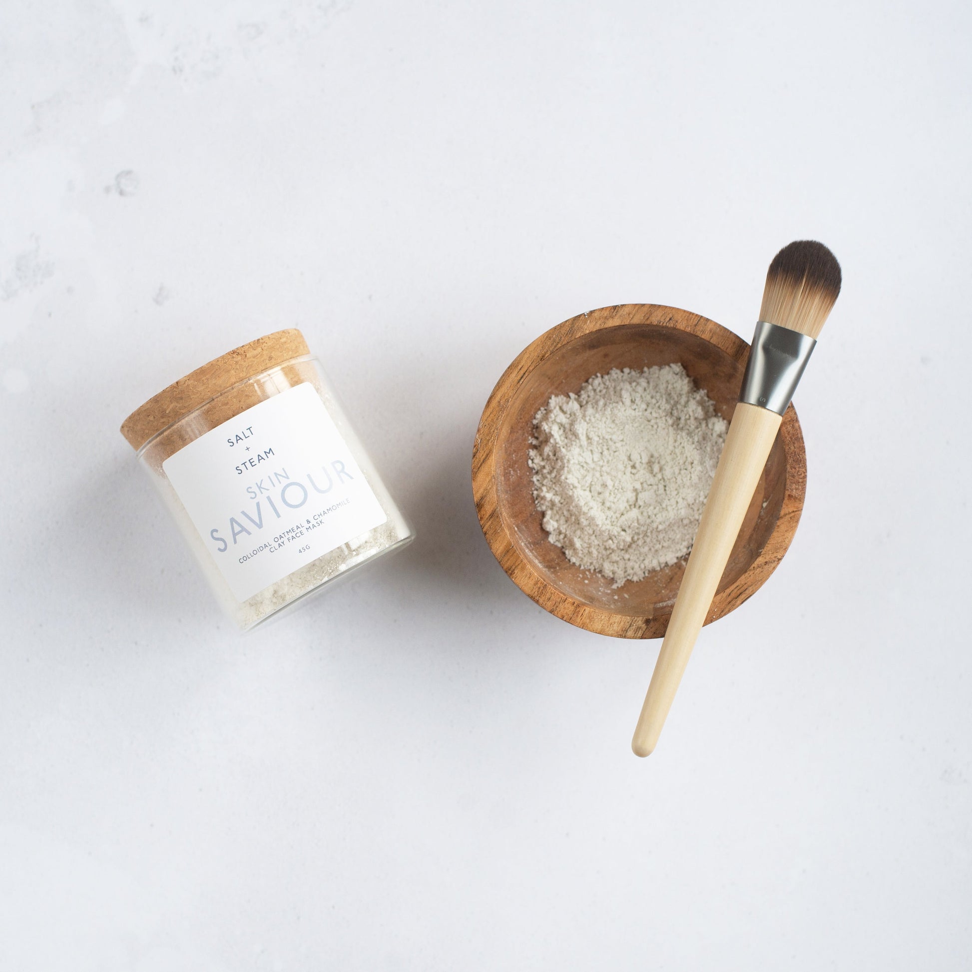 Salt + Steam Skin Saviour clay face mask being applied