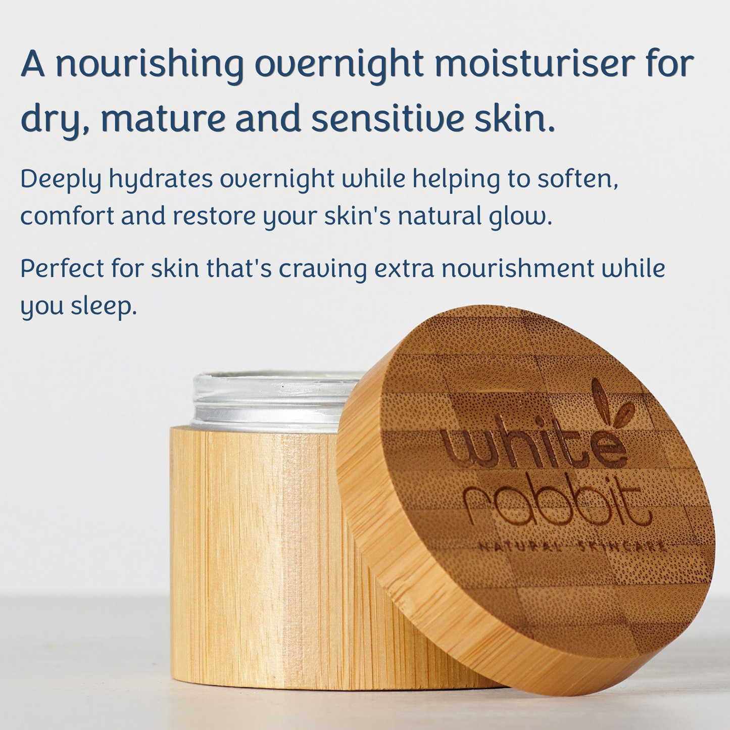 White Rabbit natural skincare overnight moisturiser in a bamboo jar with its lid leaning against it, shown on a light grey background with descriptive text.