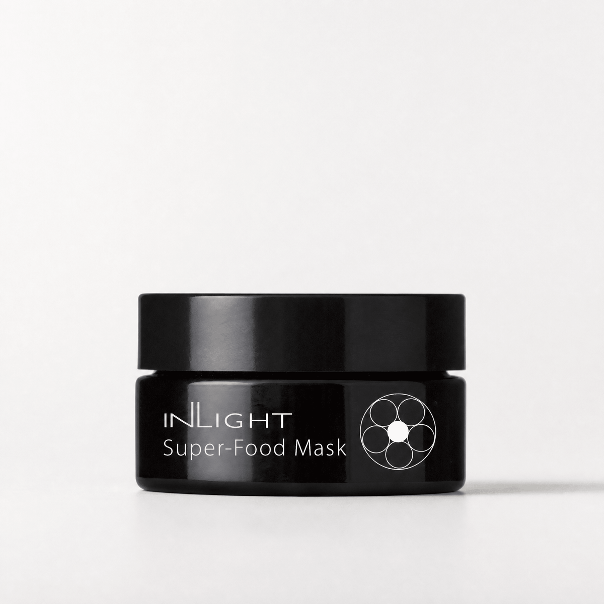 Black jar of Inlight Beauty Super-Food Mask 25ml on a white background