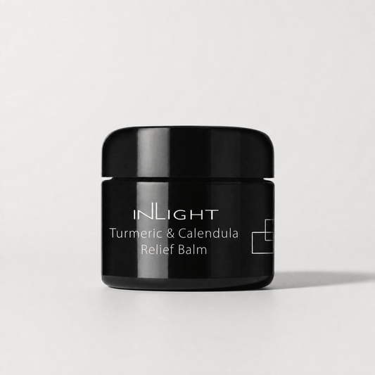 Black jar of Inlight Beauty Turmeric & Calendula Relief Balm 45ml on a light grey background