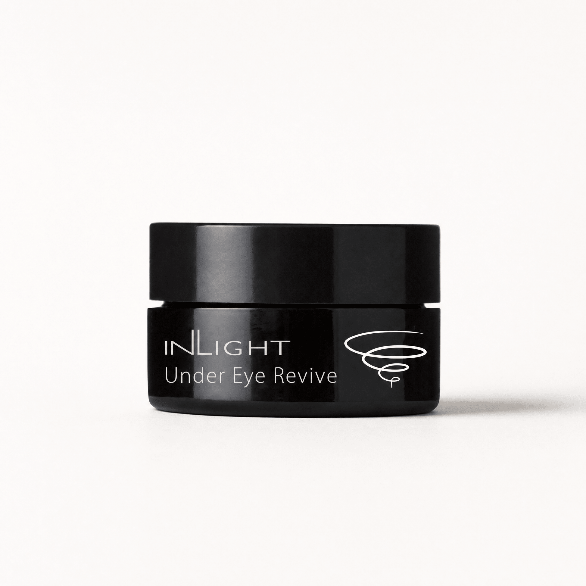 Black jar of Inlight Beauty Under Eye Revive 12ml cream on a white background
