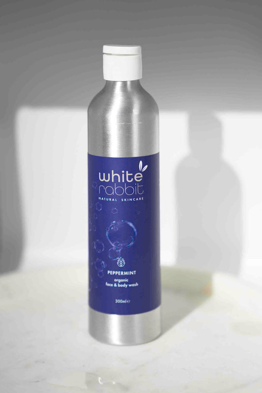 Bottle of White Rabbit skincare product on a light background