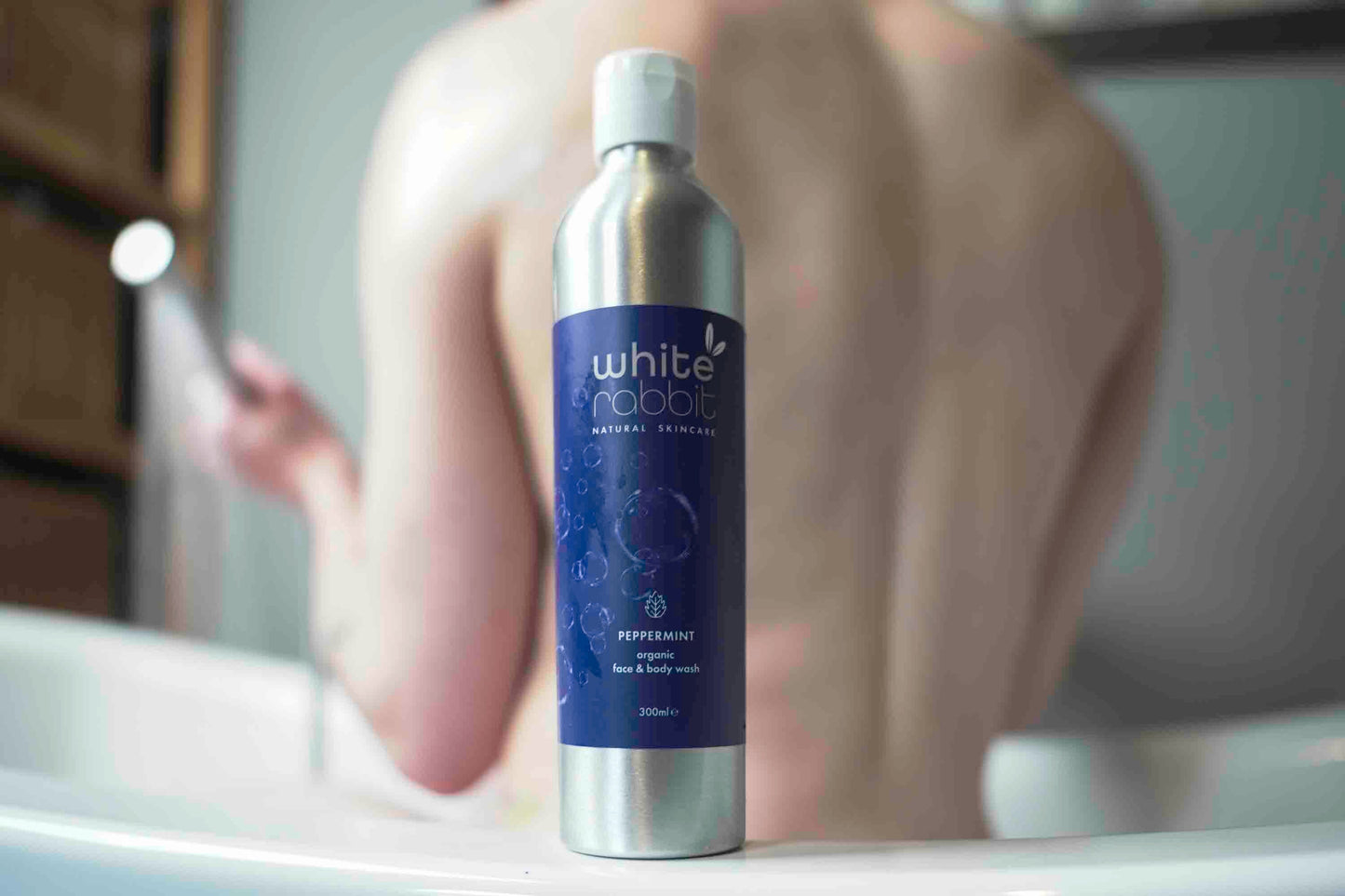 Bottle of 'White Rabbit' peppermint mouthwash on a bathroom counter with blurred background