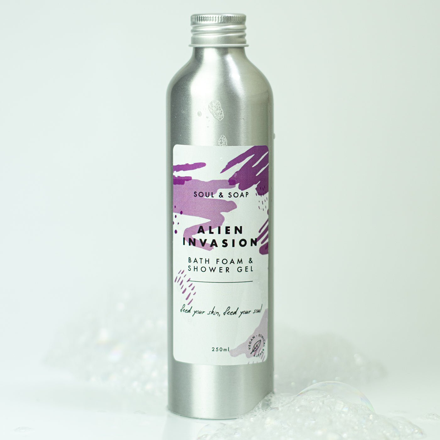Silver bottle of 'Alien Invasion' bath foam and shower gel with a purple label on a white background.