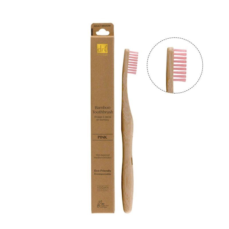 Bamboo toothbrush with pink bristles and packaging on a white background