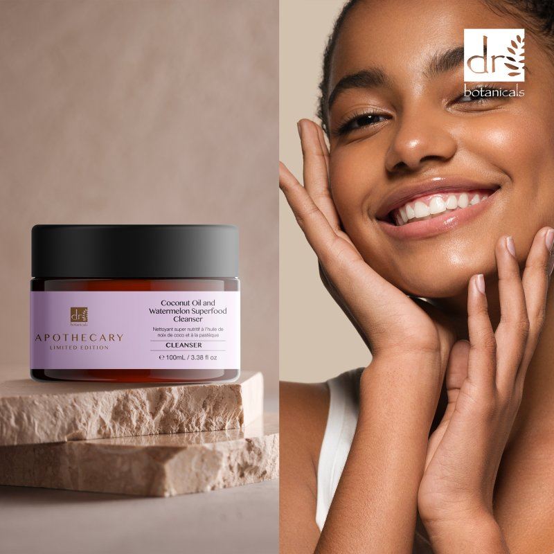 Skincare product jar with a woman touching her face, featuring Dr Botanicals branding.