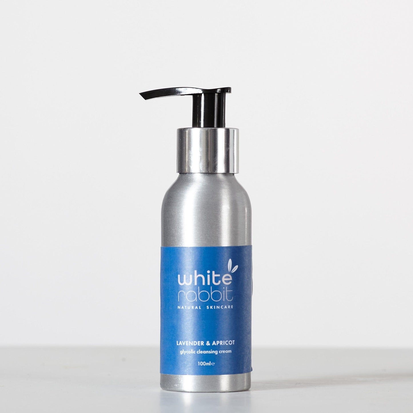Silver bottle of White Rabbit Brightening Lavender & Apricot Glycolic Acid Cream Cleanser 100ml with blue label on a white background