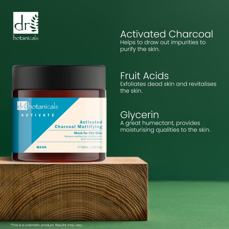 Dr Botanicals activated charcoal mask on a wooden block with green background and product benefits text.