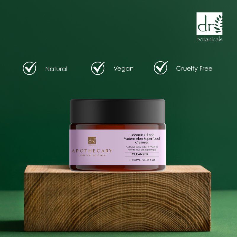 Jar of cleanser with Dr Botanicals branding on a wooden block against a green background