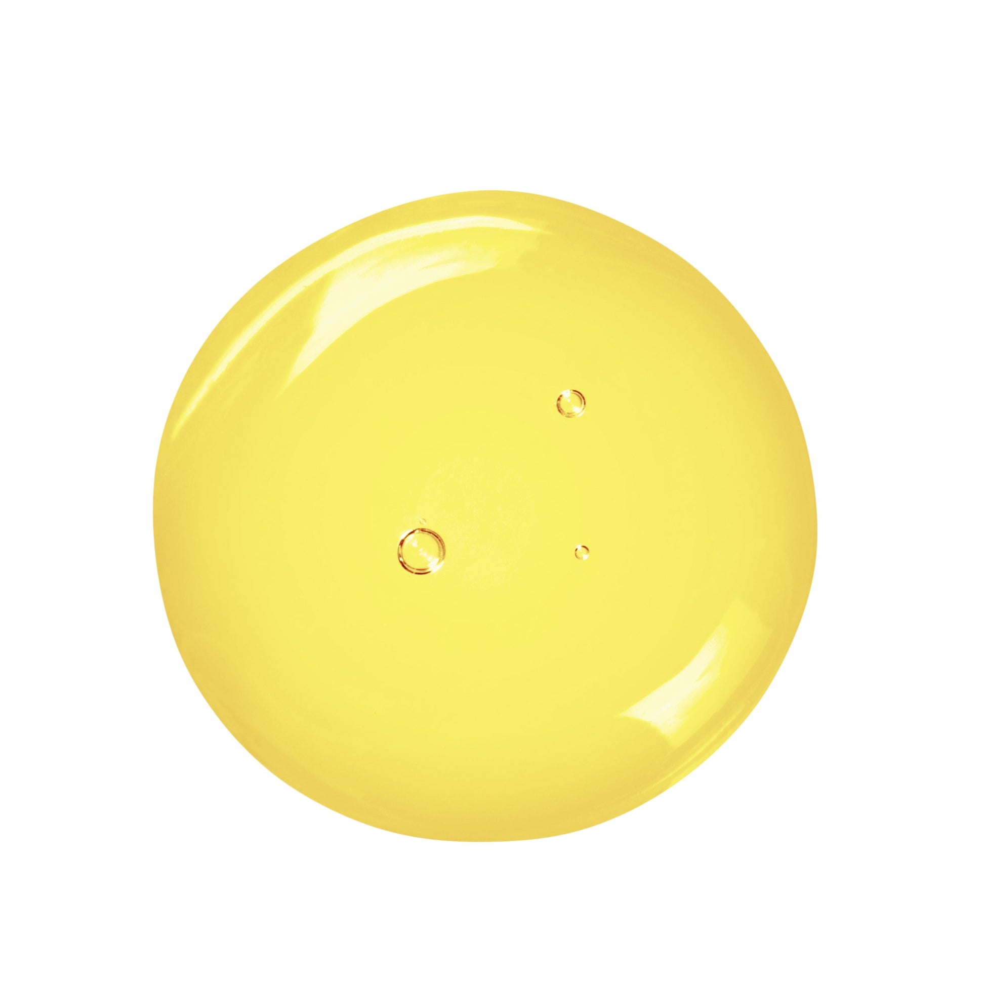 Yellow drop of oil cleanser on a white background
