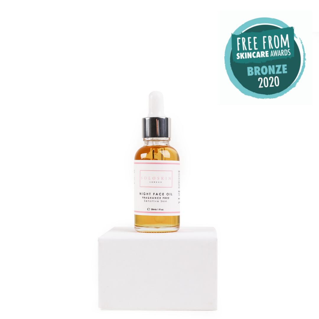 Skincare oil bottle with dropper on a white block, featuring a 'Free From Skincare Awards Bronze 2020' badge.