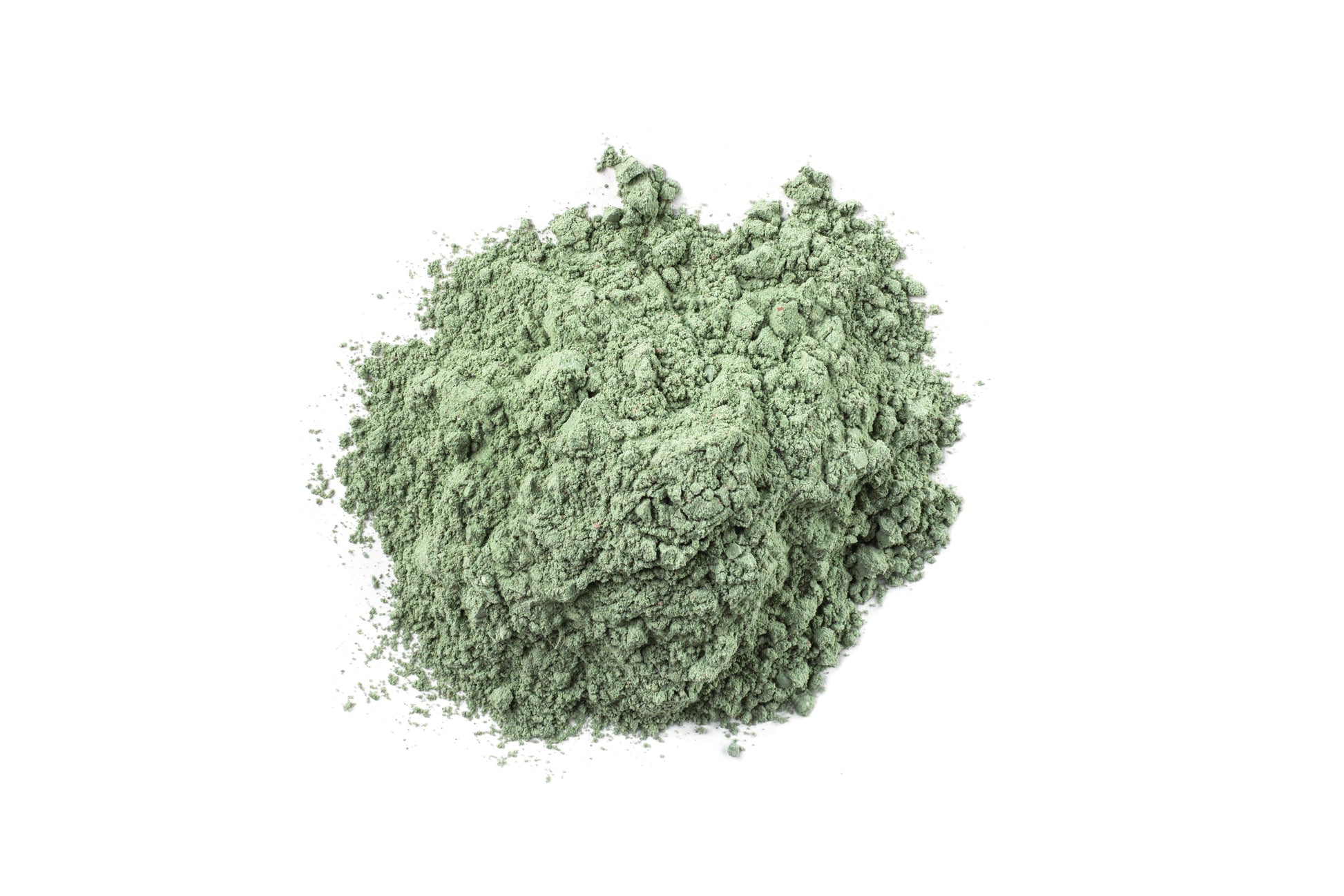 Green powder (mask contents) on a white background