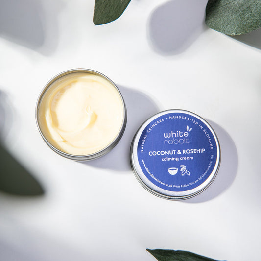 Coconut and rosehip calming cream in a tin with a blue label on a white background