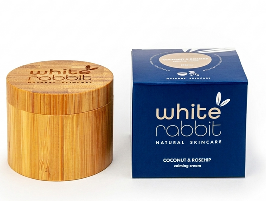 Wooden jar and blue box of White Rabbit Natural Skincare on a white background