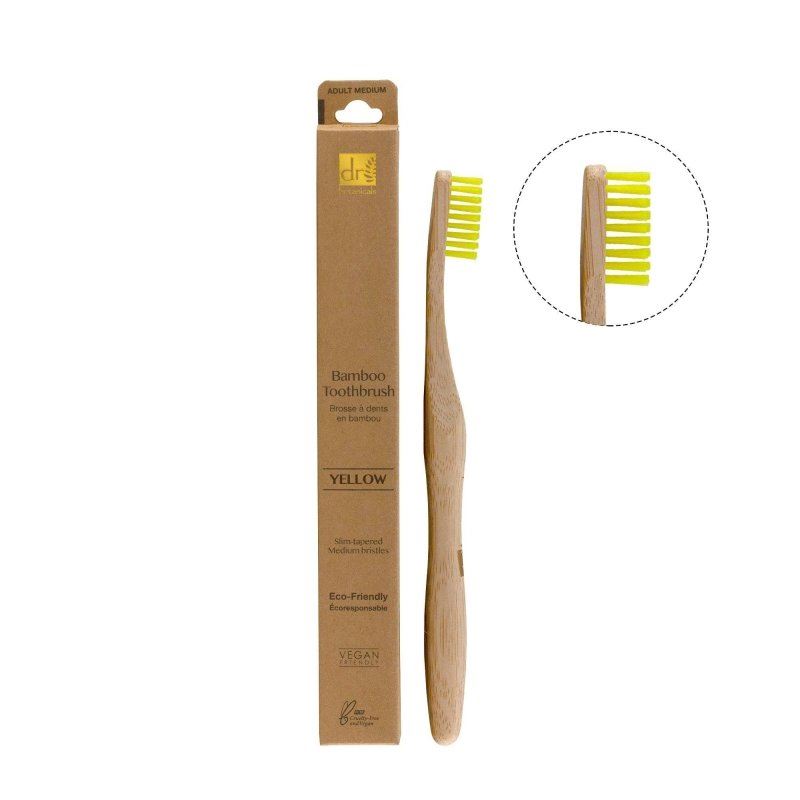 Bamboo toothbrush with yellow bristles and packaging on a white background