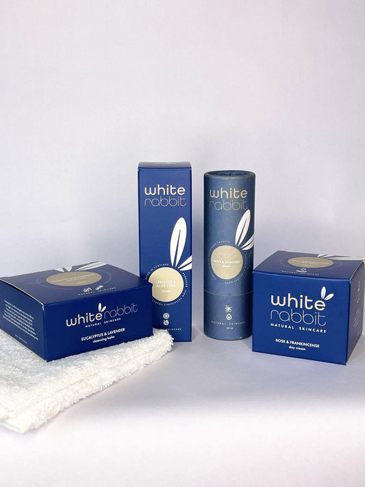 White Rabbit skincare products including boxes and bottles on a white background