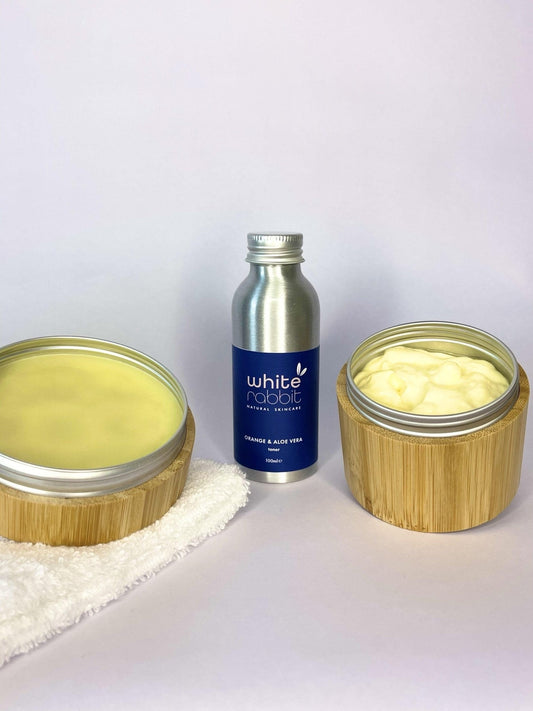 Two containers with cream-like substance and a bottle labeled 'White Nudal' on a white background