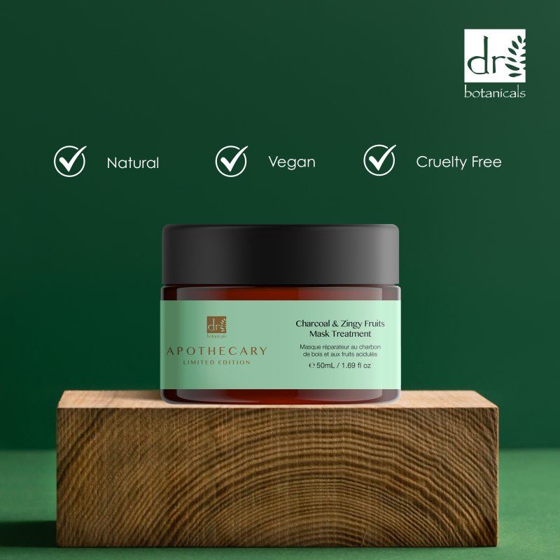 Cosmetic jar with green label on wooden block against a green background, featuring Dr Botanicals branding.