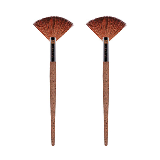 Two brown makeup brushes with cork handles on a white background