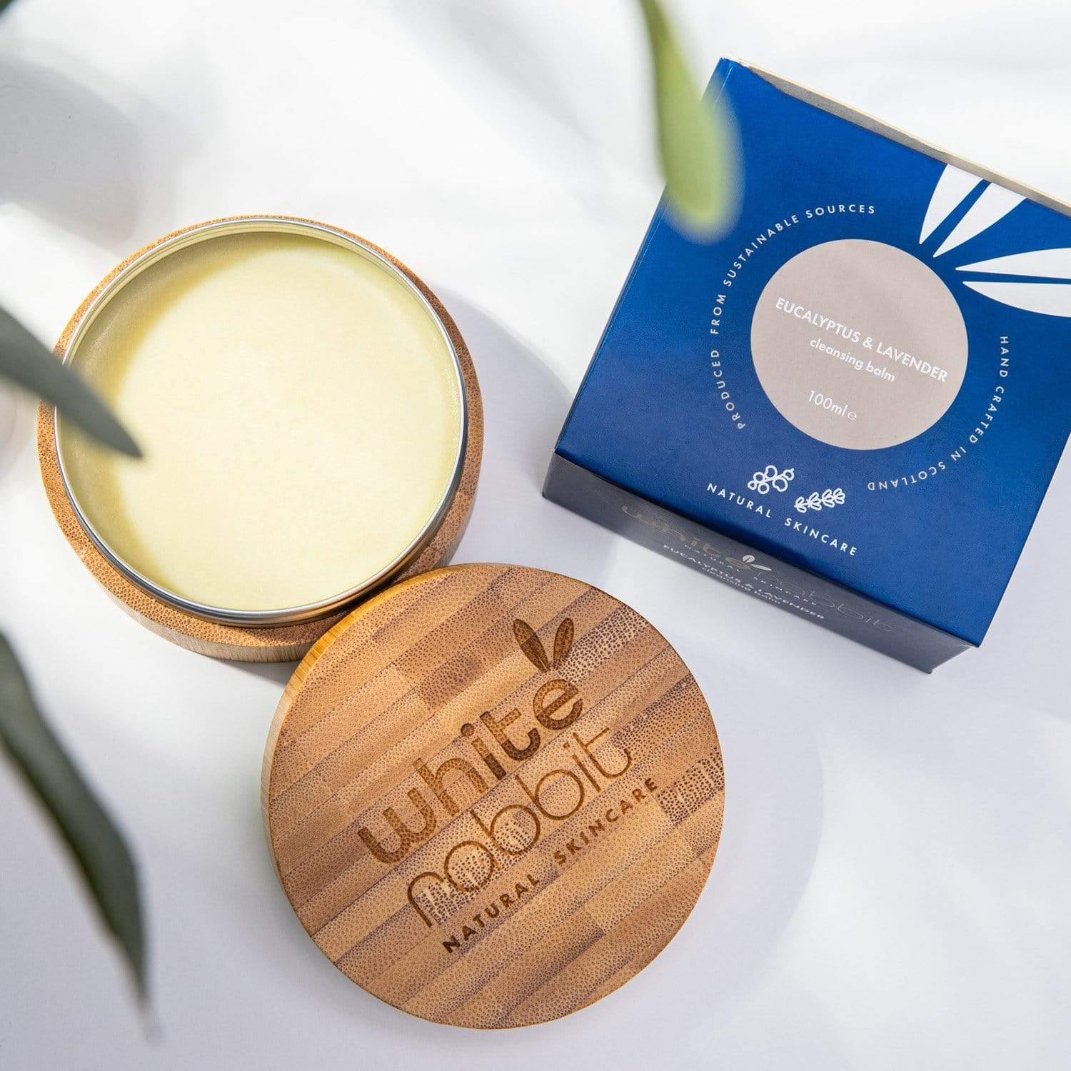 White Rabbit Natural Skincare product with wooden lid and blue packaging on a white background