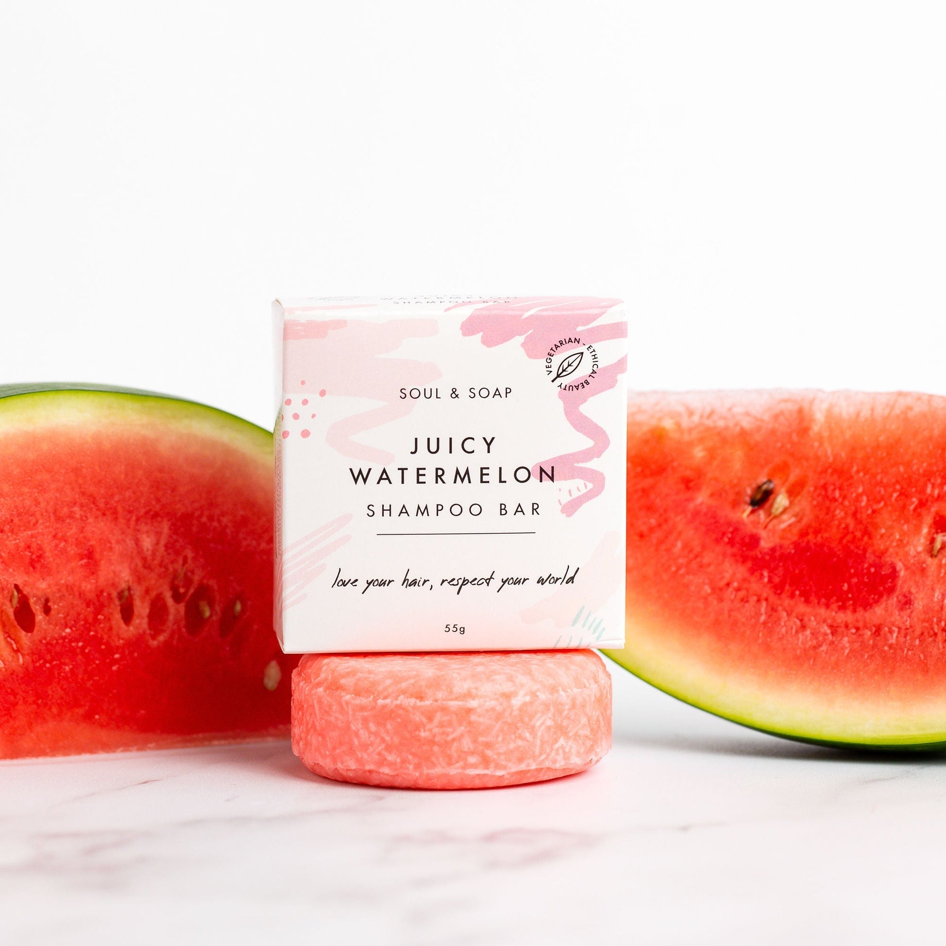 Shampoo bar with 'Juicy Watermelon' flavour packaging, surrounded by watermelon slices on a white background.