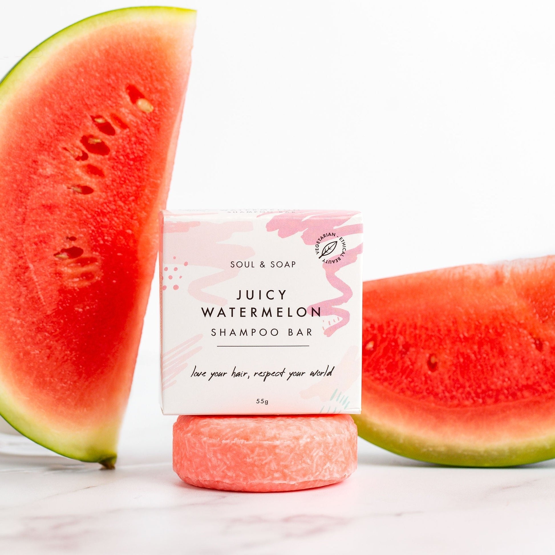 Juicy Watermelon shampoo bar with watermelon slices on a white background