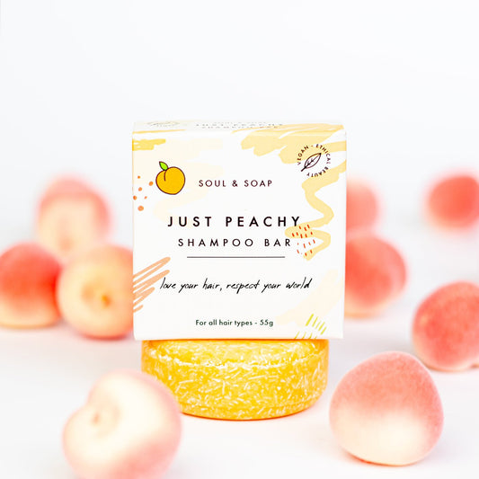 Shampoo bar packaging with peaches on a white background