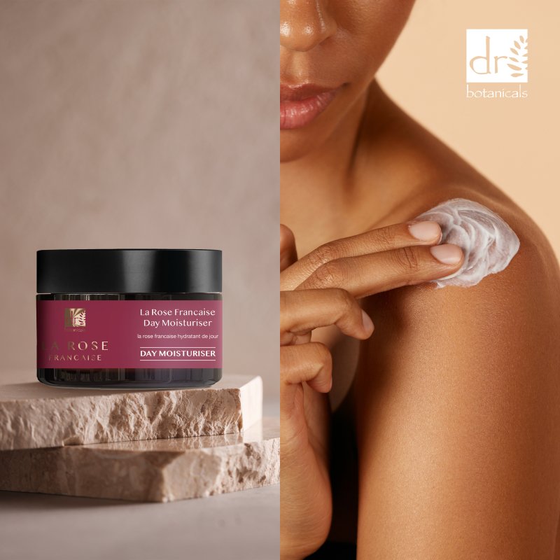 La Rose Française Day & Night Moisturizer jar with a person applying cream to their shoulder.