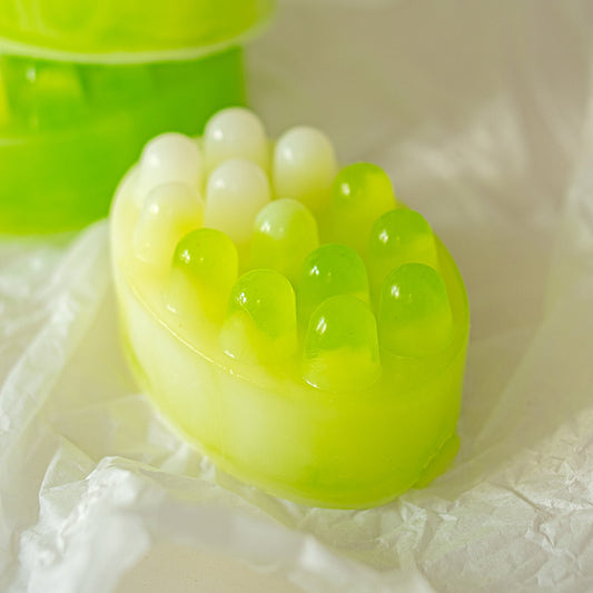 Green and white textured soap bar on a white background