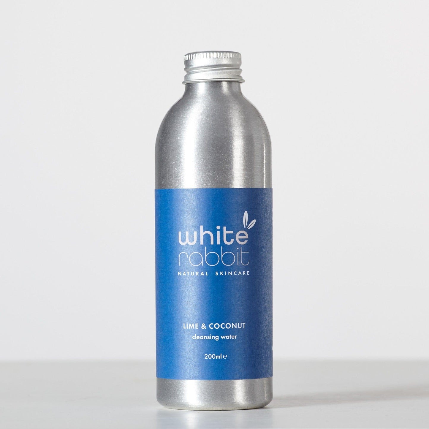 Silver bottle with blue label featuring 'White Rabbit' on a white background