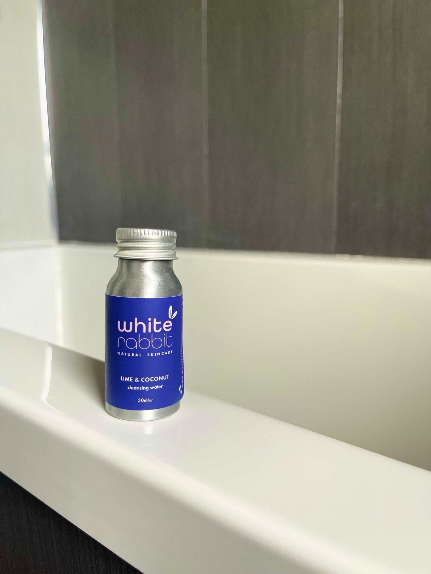 White Rabbit skincare product bottle on a white surface with a neutral background