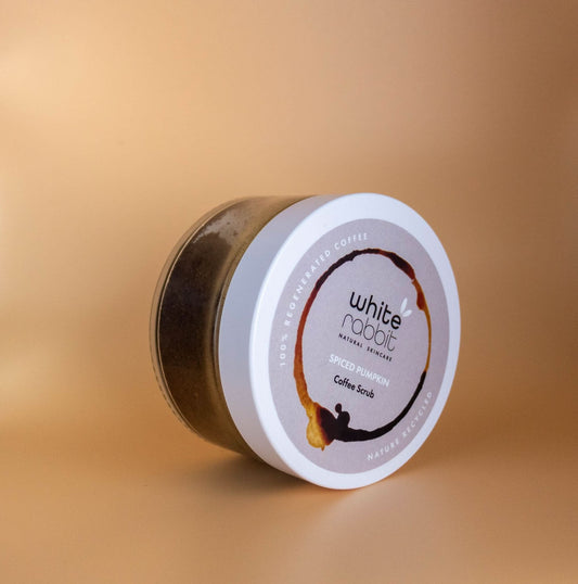 Jar of White Rabbit coffee scrub on a beige background