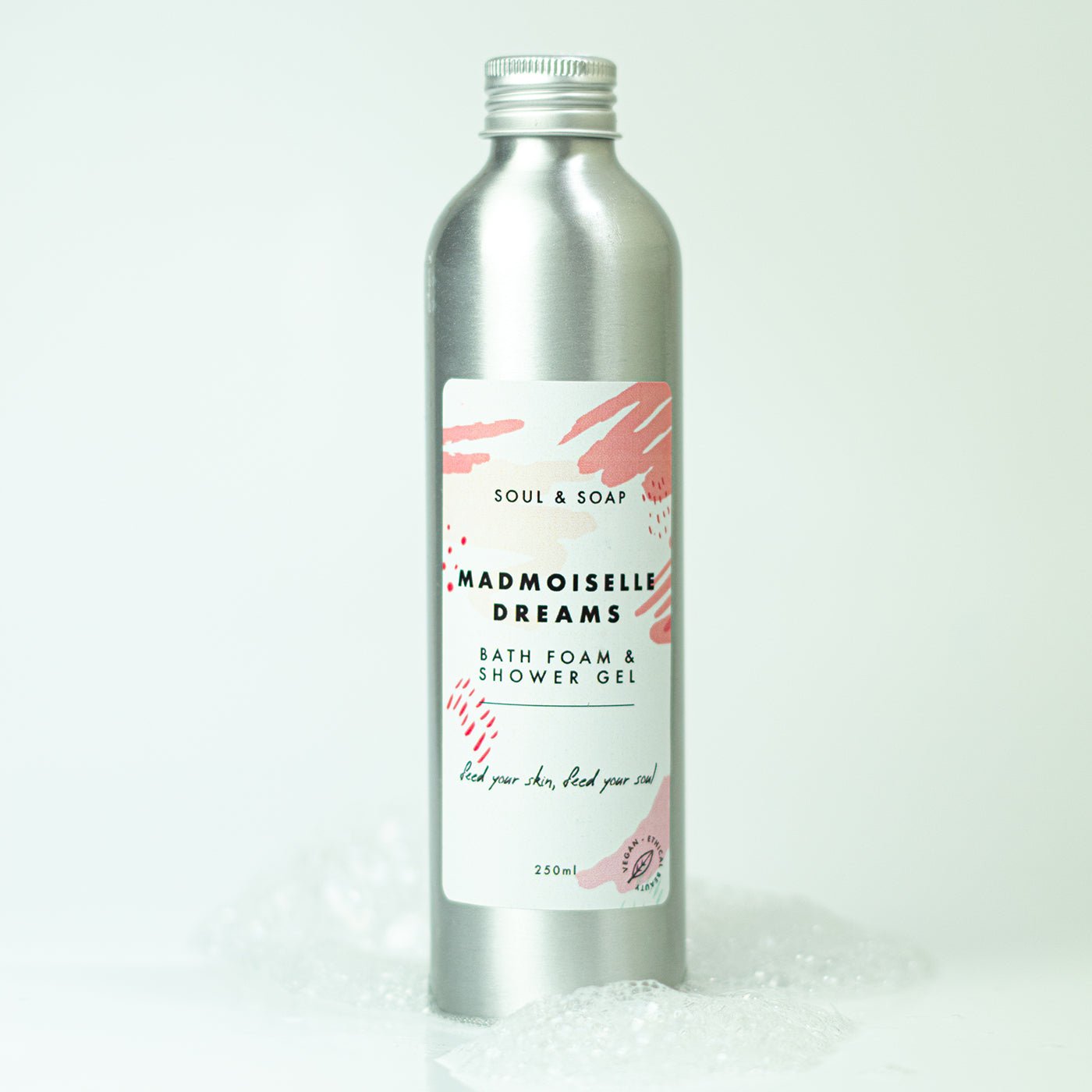 Silver bottle of Madmoiselle Dreams bath foam and shower gel with a white label on a white background.