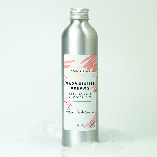 Silver bottle of Madmoiselle Dreams bath foam and shower gel with a white label on a white background.