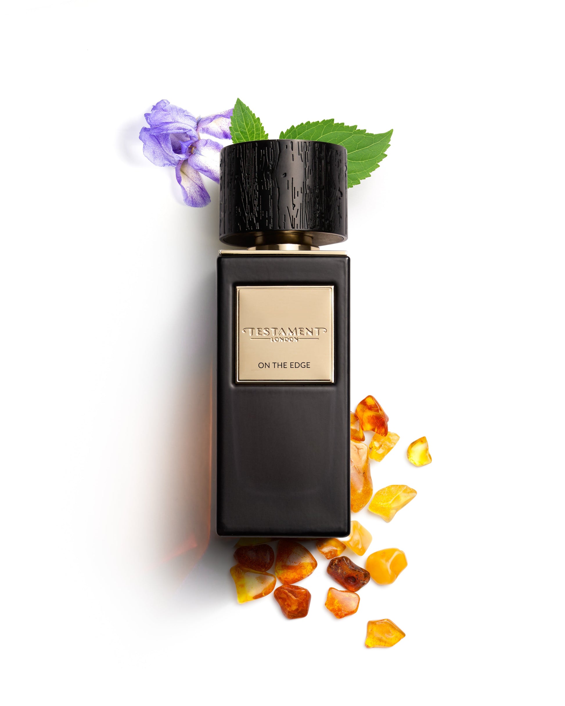 Perfume bottle labeled 'Testament' with decorative elements on a white background