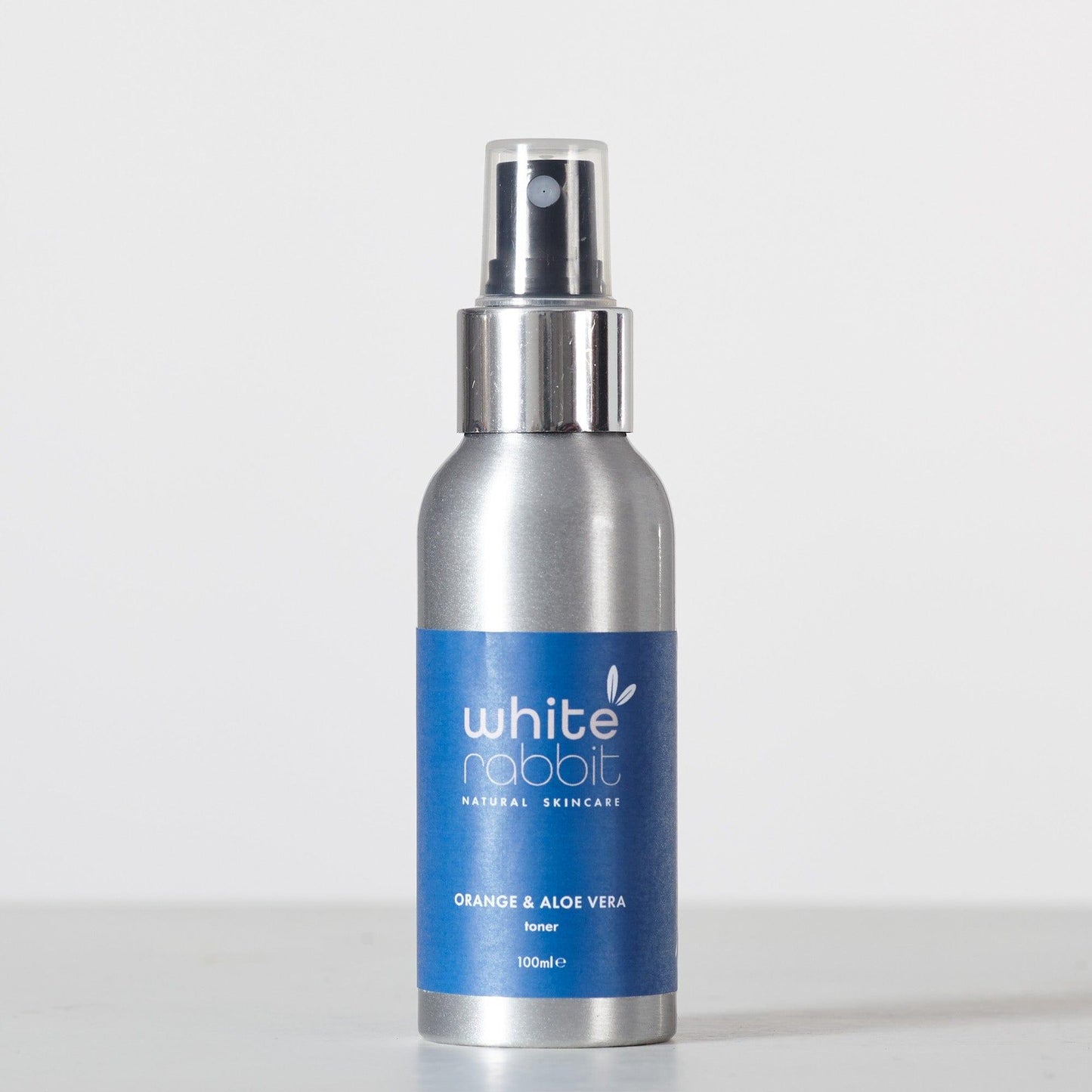 Silver spray bottle with a blue label on a white background