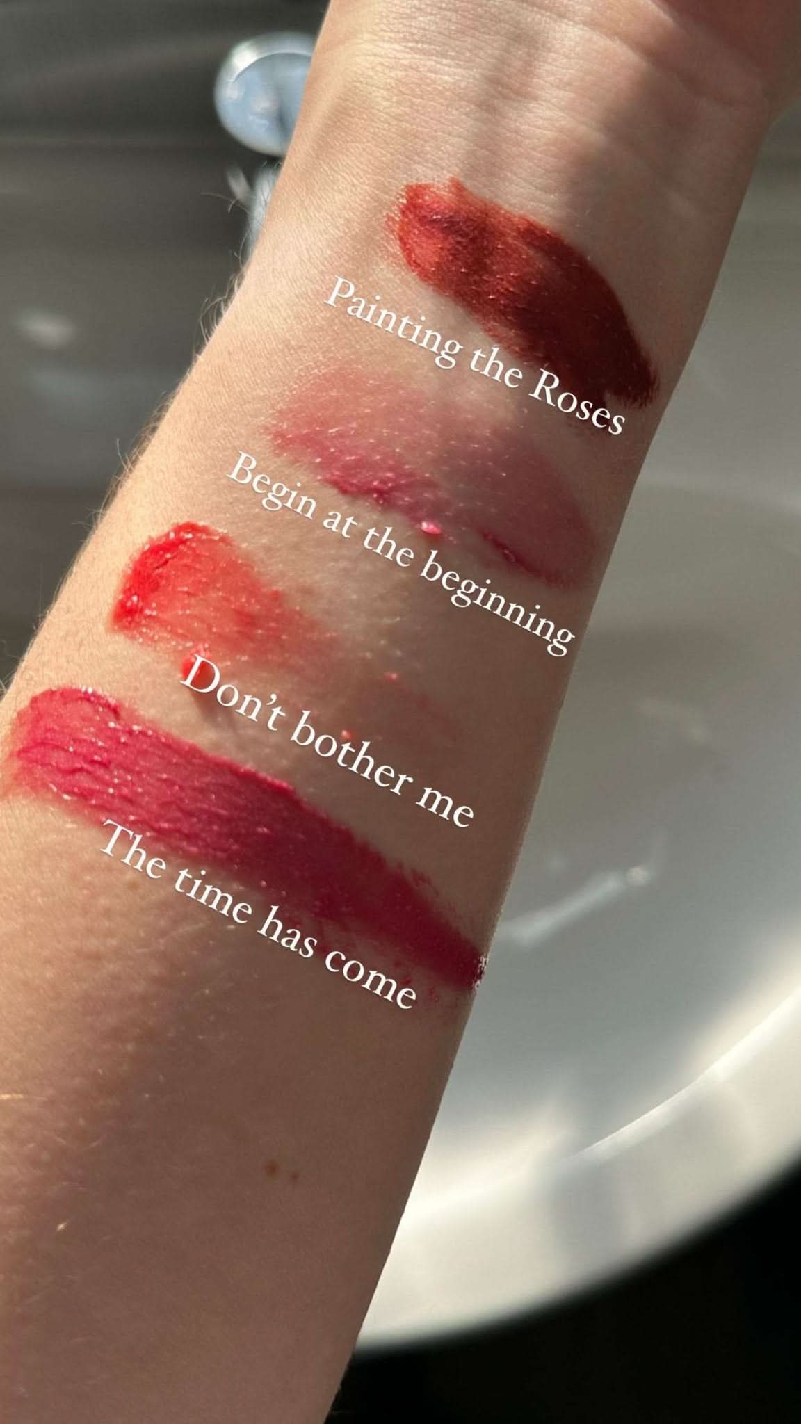 White Rabbit Organic Tinted Lip & Cheek Balm swatches on a wrist with text labels