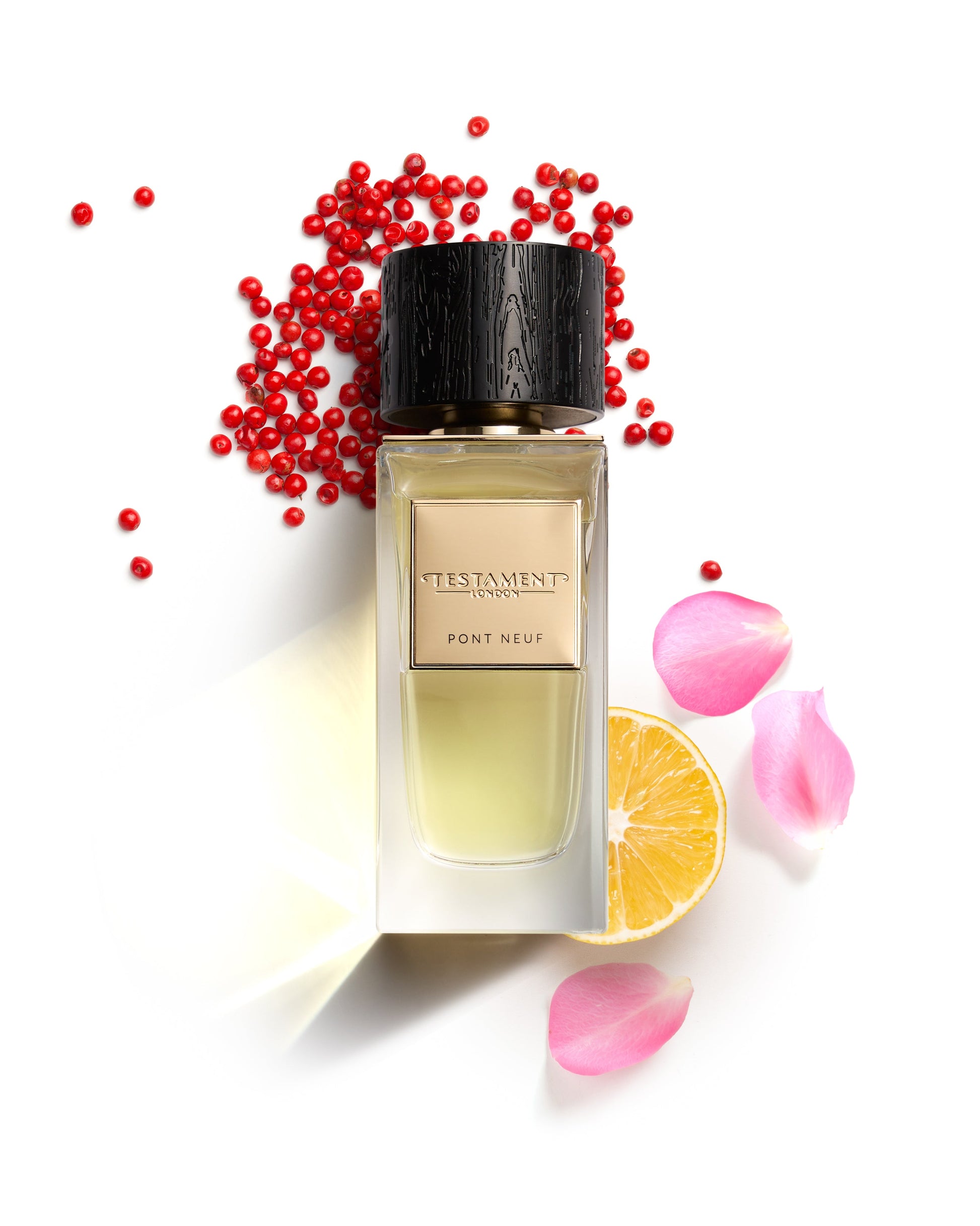 Perfume bottle with red berries and flowers on a white background