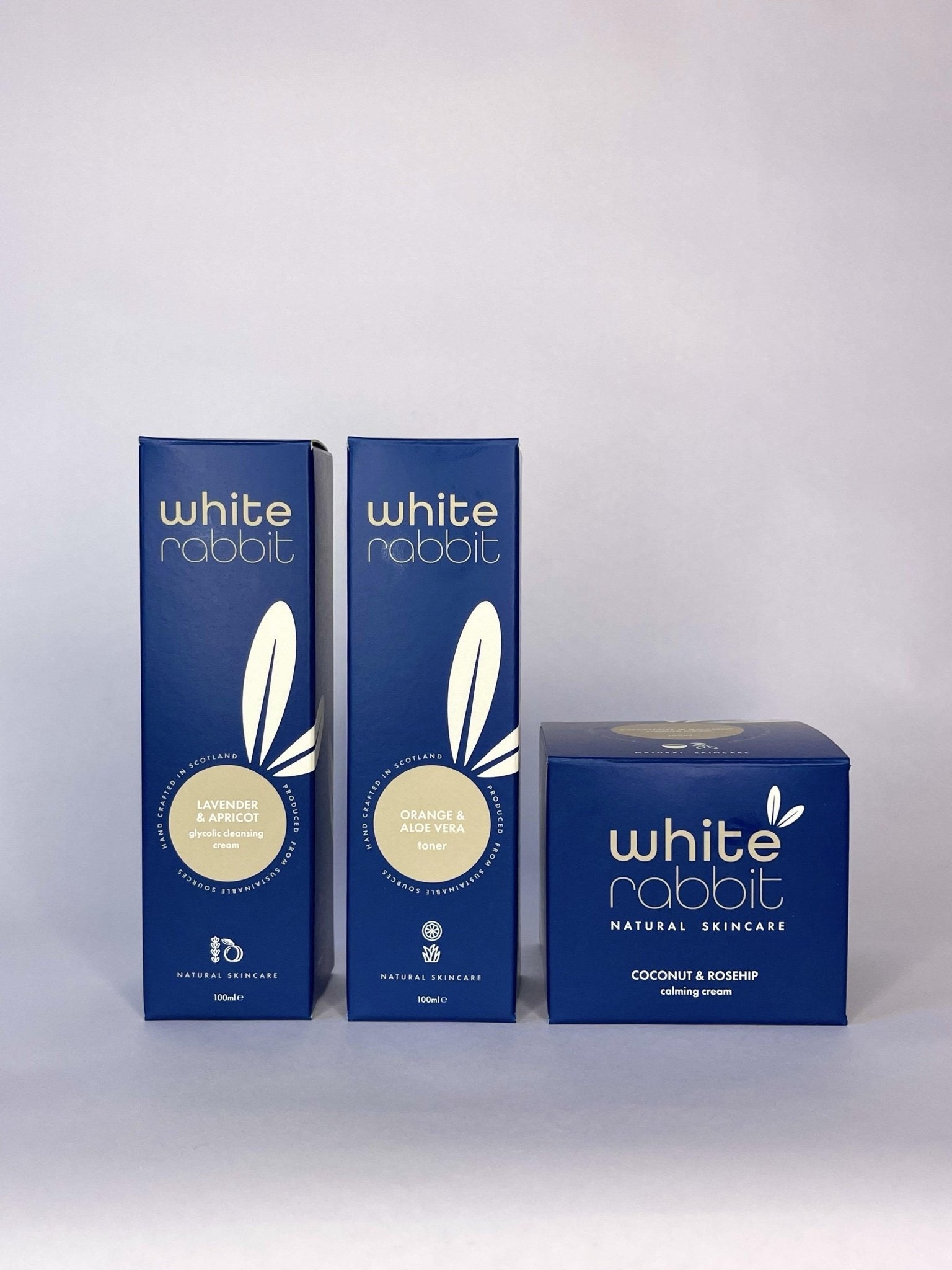 Three blue boxes of White Rabbit skincare products on a white background