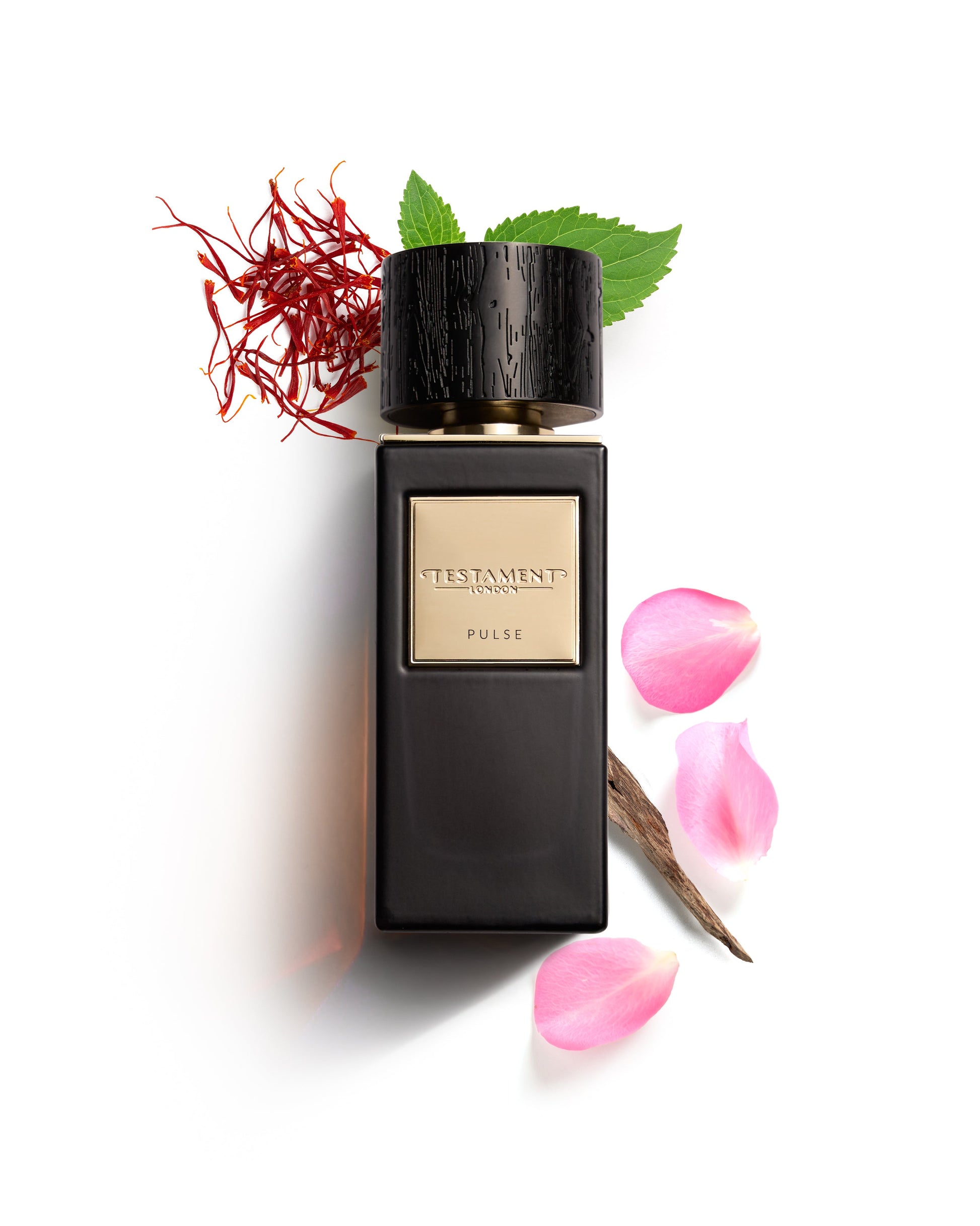 Black perfume bottle with saffron and pink petals on a white background